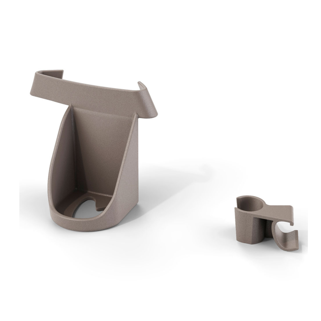 The Cane Holder for ByAcre Ultralight Carbon Fiber Rollators includes two taupe molded plastic clips—one large with a wide base and angled sides, one smaller and rounded—both with curved openings, shown on a plain white background.